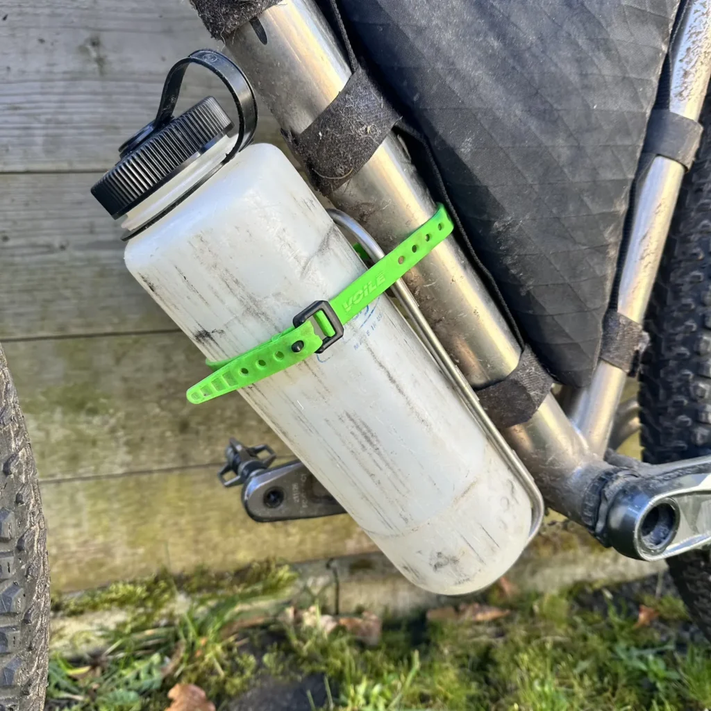 Ultralight water bottle on down tube of bike with voile strap